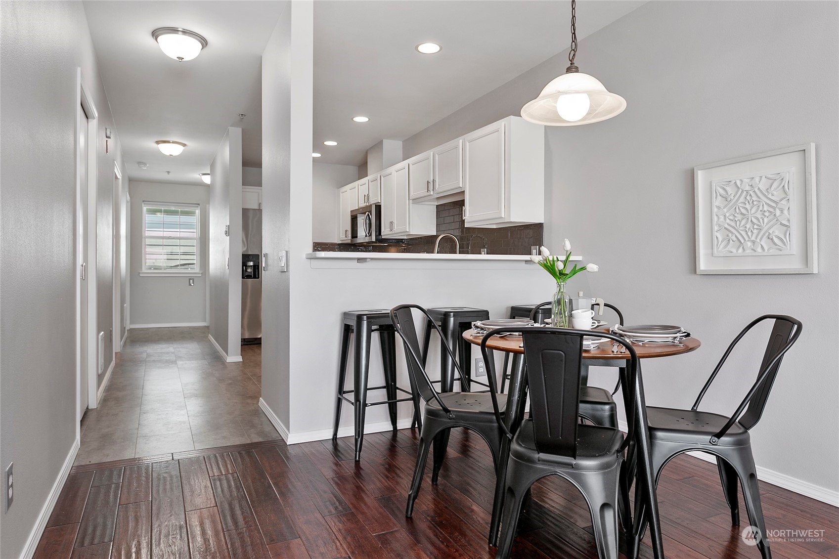 1011 Bancroft Street, Unit 303 Bellingham, WA 98225 - Photo 9 of 40 an open kitchen with dining table and chandelier