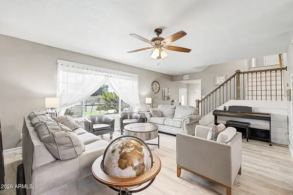 a living room with furniture a rug and a chandelier
