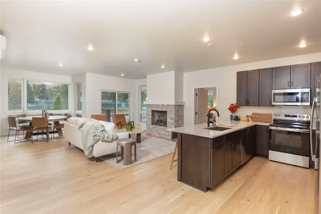 a living room with stainless steel appliances granite countertop furniture and a kitchen view