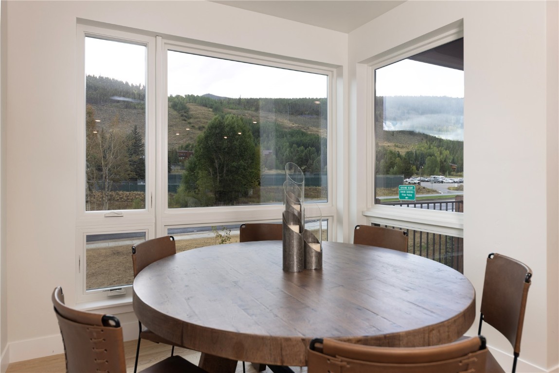125 West Keystone Road, Unit 301 Keystone, CO 80435 - Photo 15 of 23 a dining room with furniture wooden floor and a potted plant