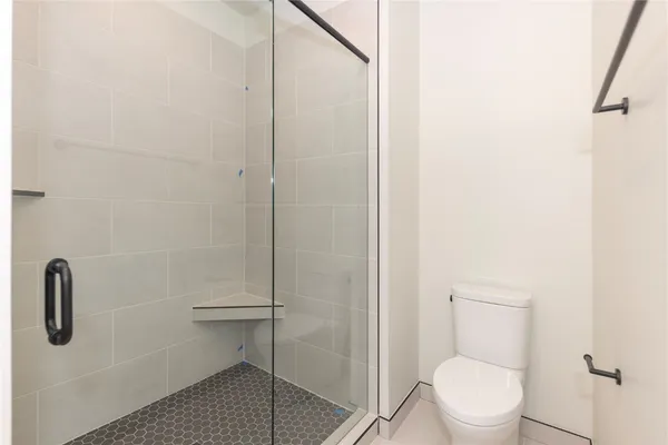 a bathroom with a sink a toilet and a large mirror