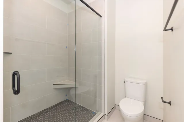 a bathroom with a sink a toilet and a large mirror