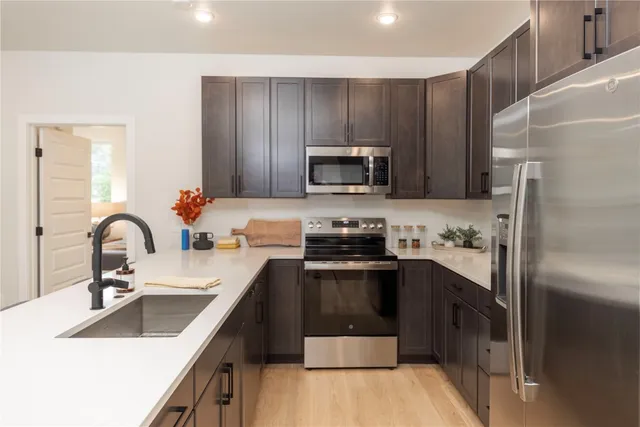 a kitchen with a sink stove and refrigerator
