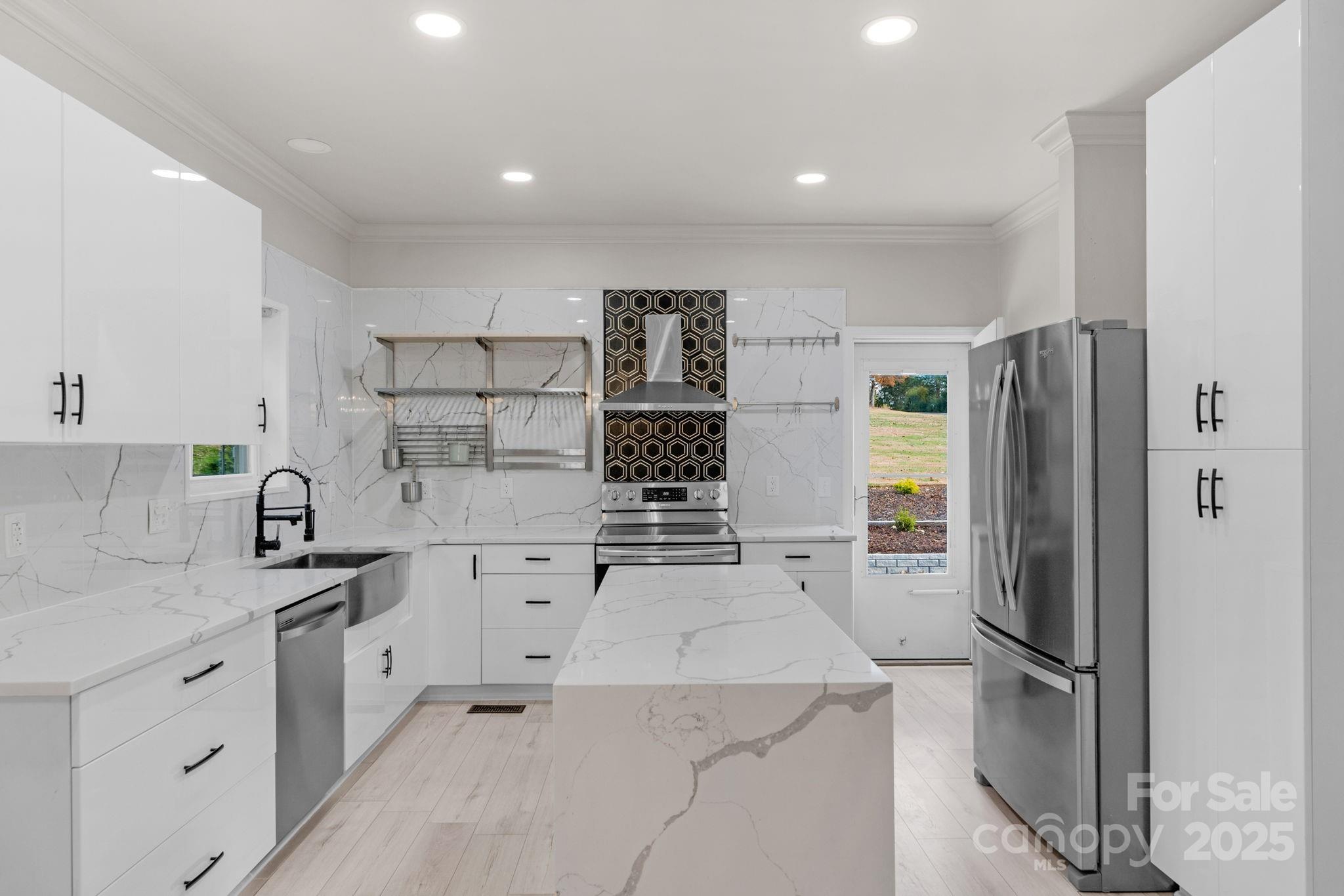 8891 Rock Hole Road Stanfield, NC 28163 - Photo 12 of 35 a kitchen with a refrigerator sink and stove