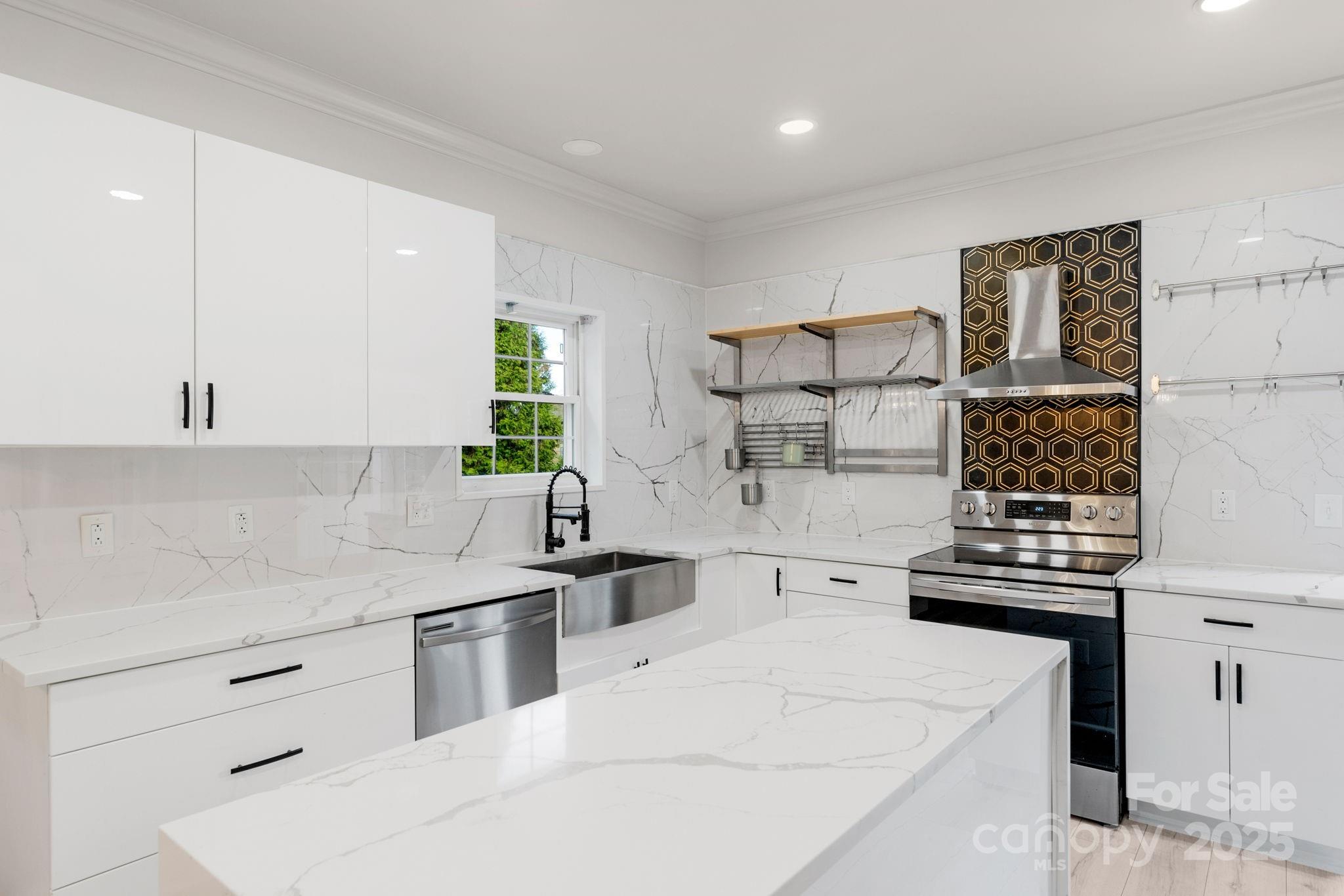 8891 Rock Hole Road Stanfield, NC 28163 - Photo 13 of 35 a kitchen with stainless steel appliances a sink stove and cabinets