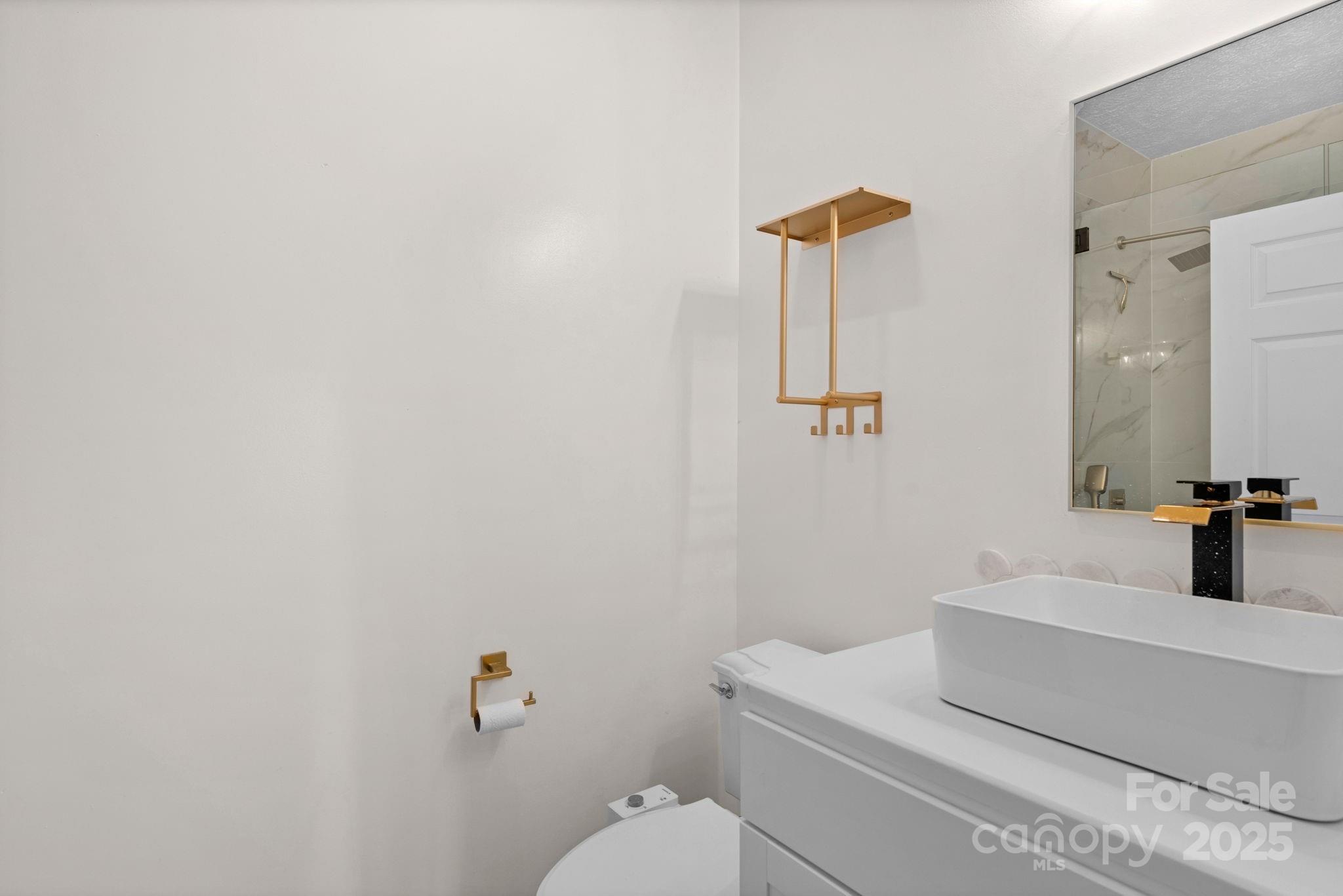 8891 Rock Hole Road Stanfield, NC 28163 - Photo 23 of 35 a bathroom with a sink and mirror with toilet