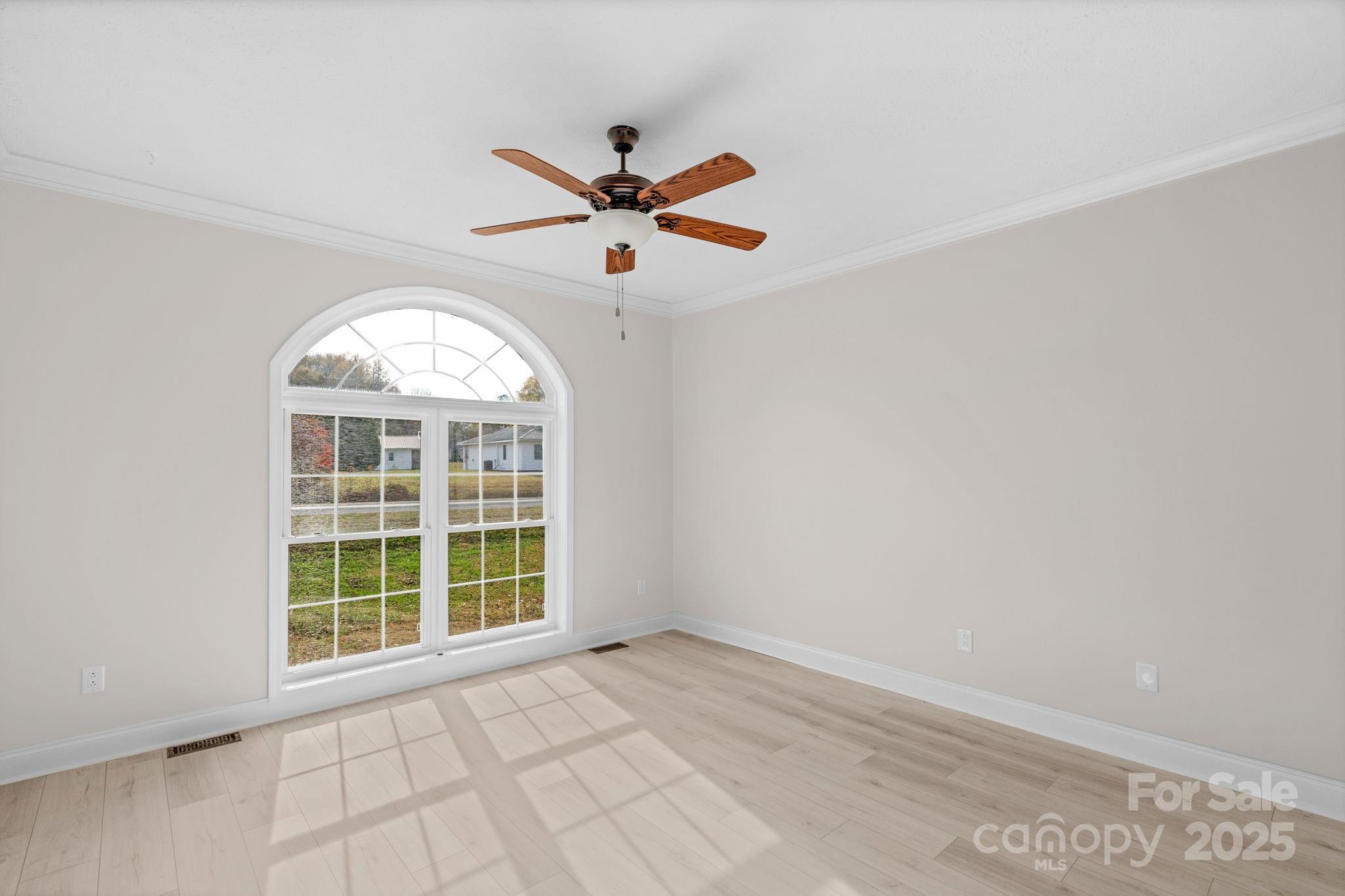 8891 Rock Hole Road Stanfield, NC 28163 - Photo 25 of 35 an empty room with a window and a fan