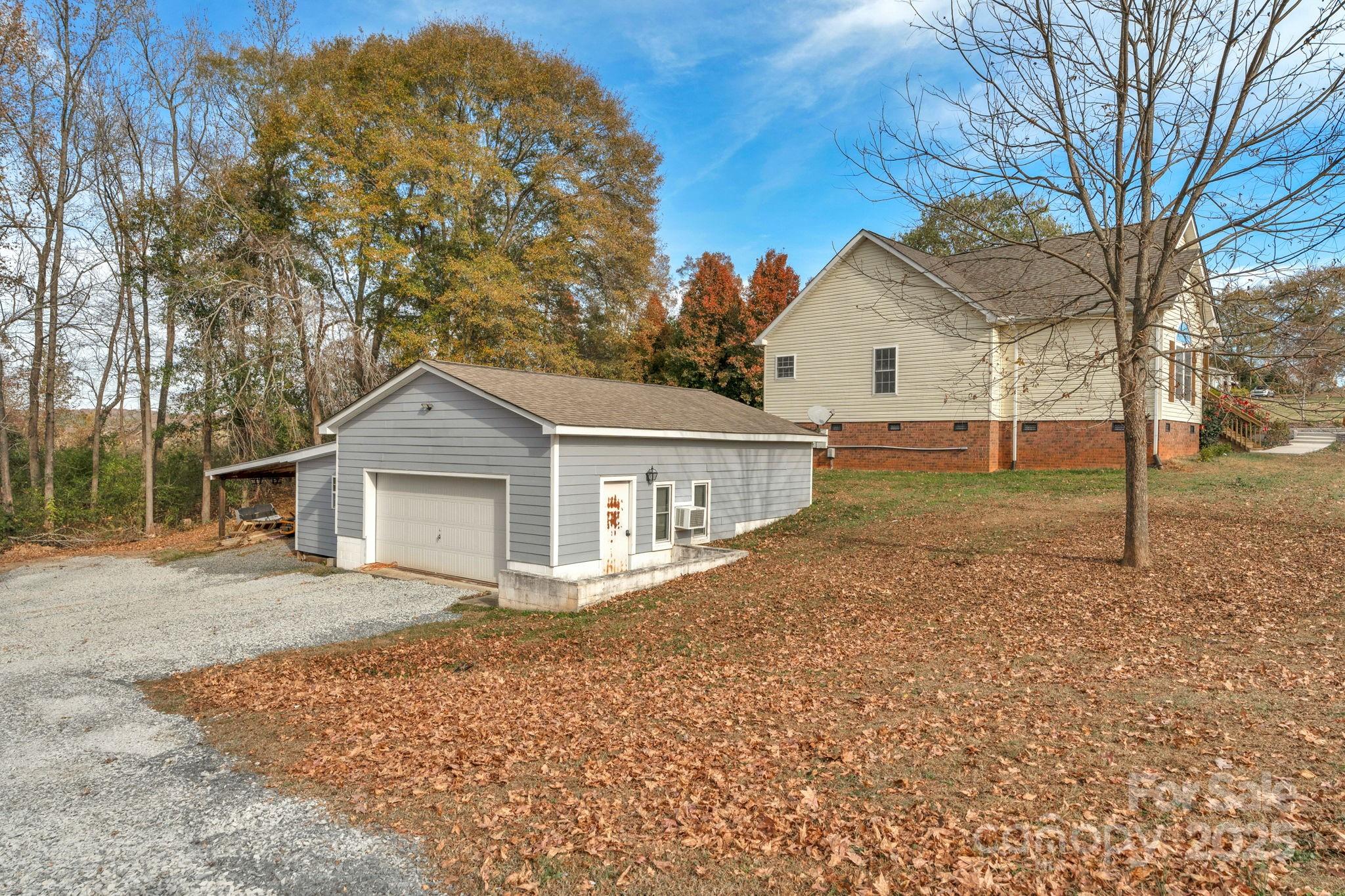 8891 Rock Hole Road Stanfield, NC 28163 - Photo 30 of 35 a view of a house with a yard