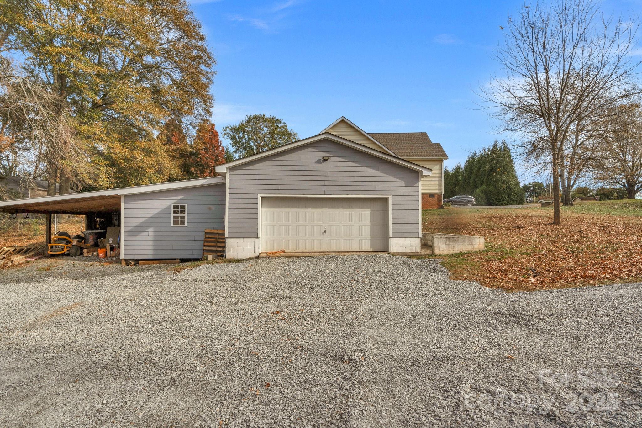 8891 Rock Hole Road Stanfield, NC 28163 - Photo 31 of 35 a front view of a house with a yard and garage