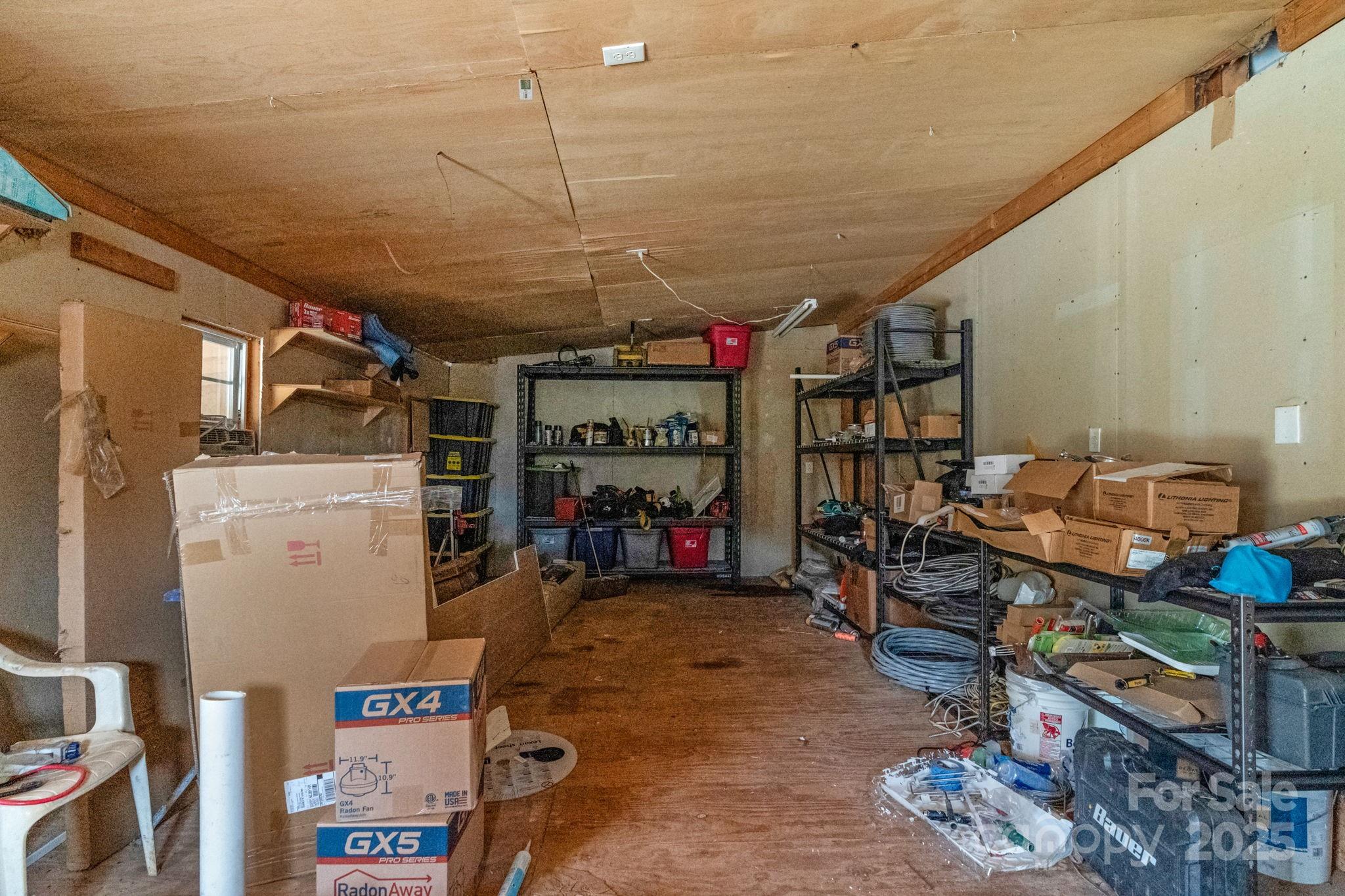 8891 Rock Hole Road Stanfield, NC 28163 - Photo 34 of 35 a view of a storage area with racks on the wall