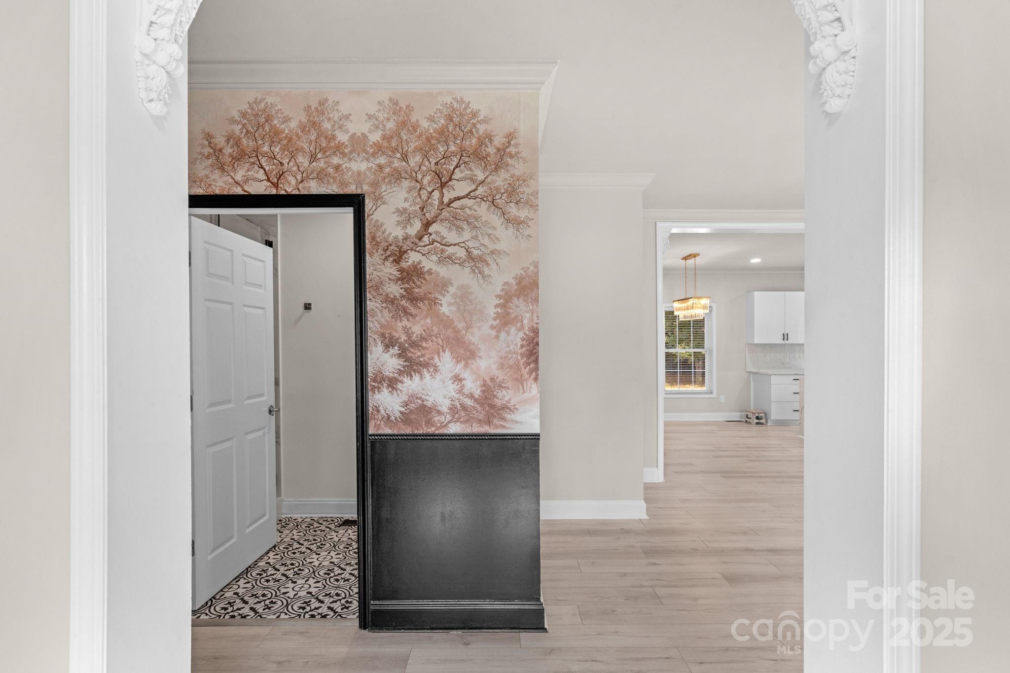 8891 Rock Hole Road Stanfield, NC 28163 - Photo 6 of 35 a view of a hallway with wooden floor and a bathroom