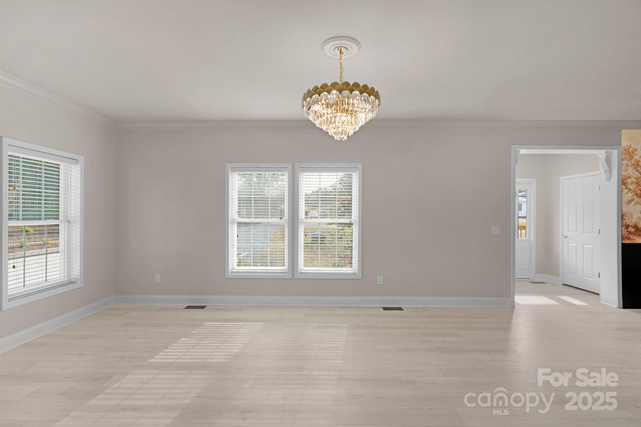 8891 Rock Hole Road Stanfield, NC 28163 - Photo 8 of 35 an empty room with wooden floor and window