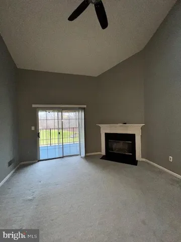 an empty room with furniture and windows
