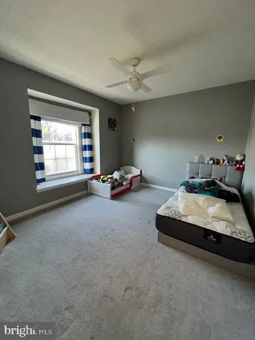 a bedroom with bed and window