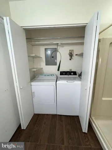 a utility room with cabinets washer and dryer