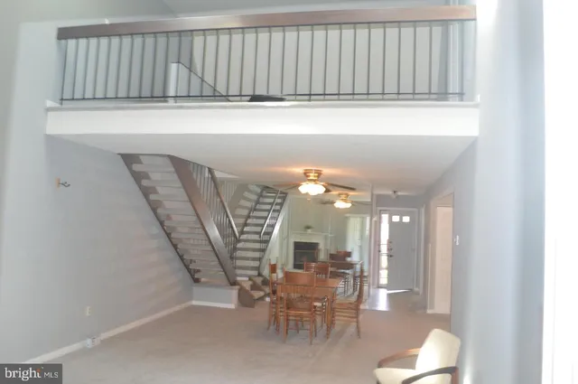 a view of a dining room with furniture and a chandelier