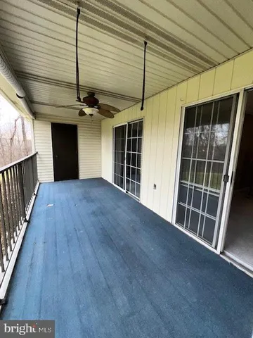 a view of a porch with furniture and next to a window