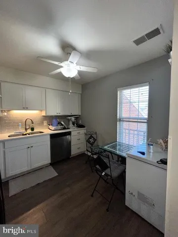 a kitchen with a sink cabinets and window