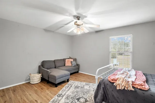 a bedroom with a bed and ceiling fan