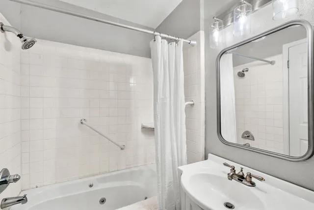a bathroom with a shower and a sink