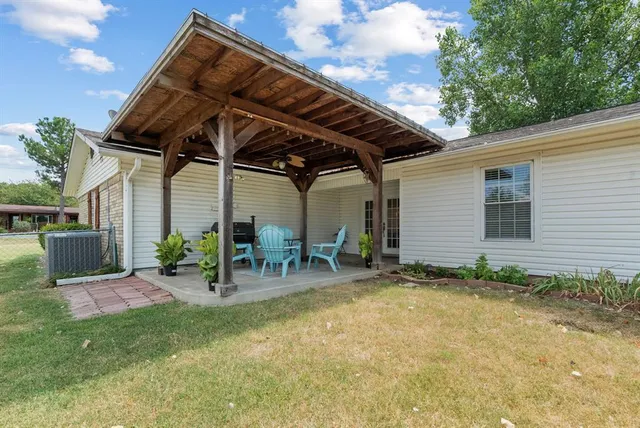 a view of backyard with outdoor seating and plants