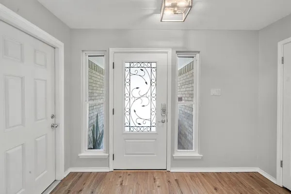 a view of an entryway with wooden floor