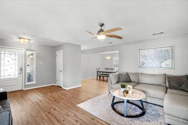 a living room with furniture a rug and a window