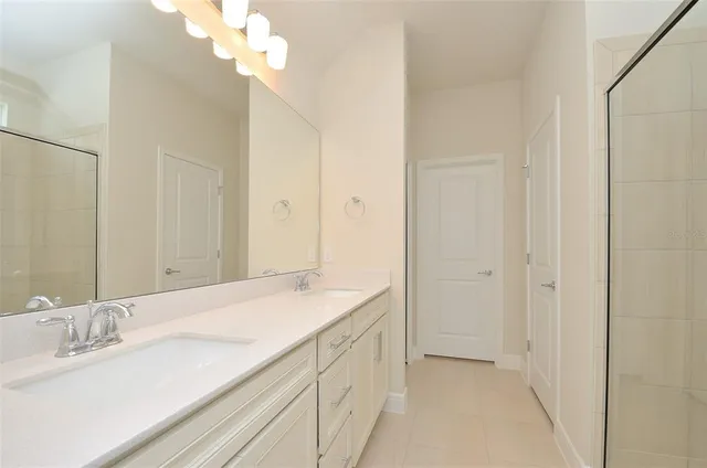 a bathroom with a sink a vanity and a mirror