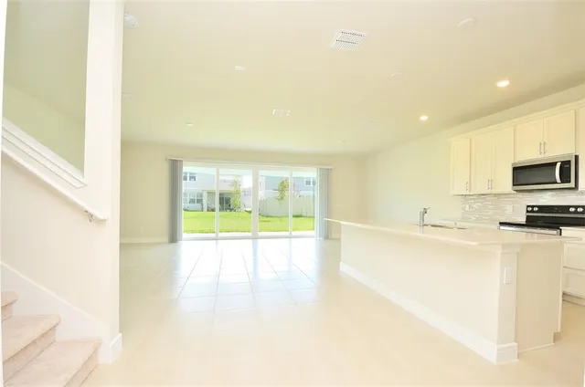 a view of an empty room and a window