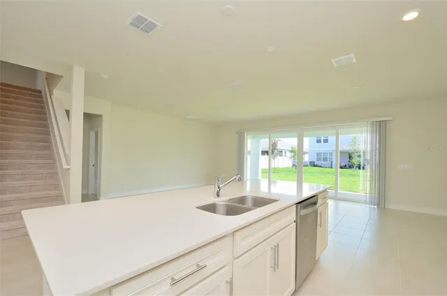 a kitchen with a sink and large window