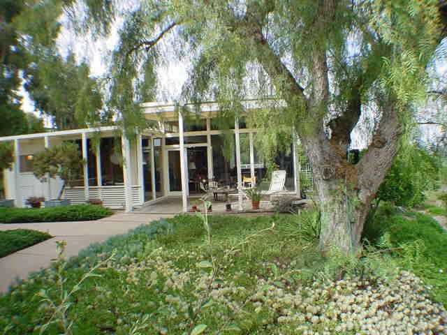 1619-1625 Gascony Road Encinitas, CA 92024 - Photo 1 of 1 a view of a chair and table in backyard of the house