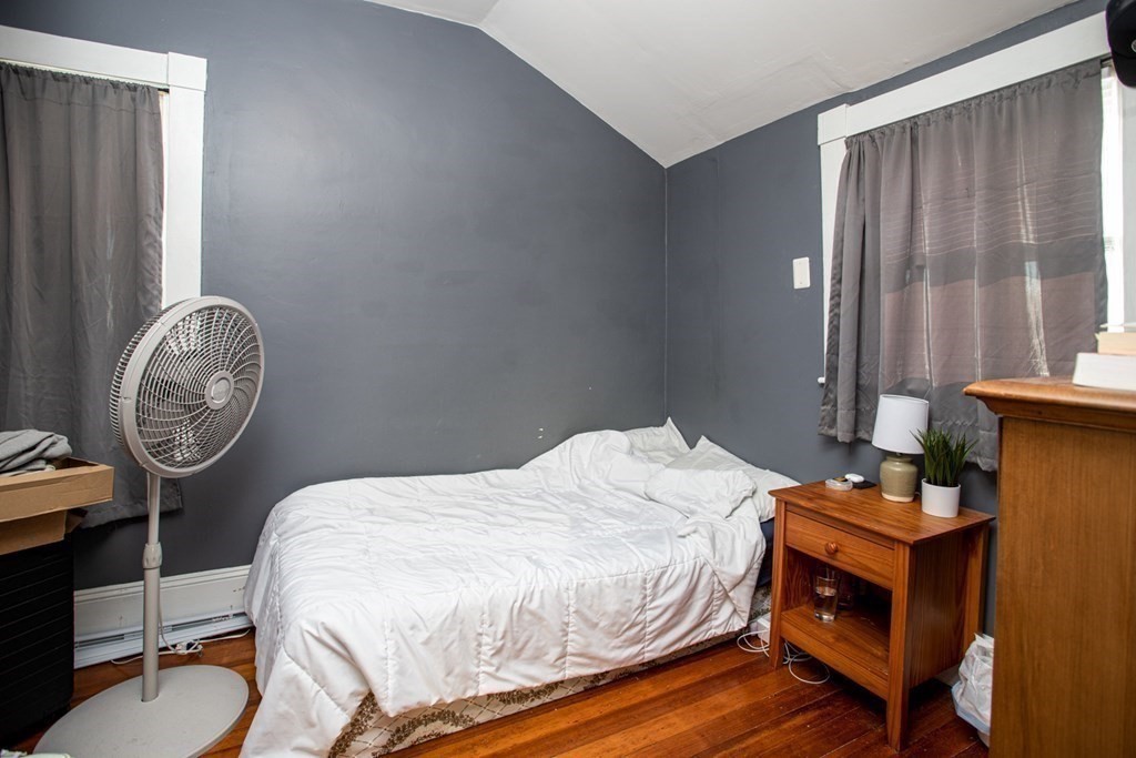 80 State Road North Dartmouth, MA 02747 - Photo 17 of 23 a bedroom with a bed and a chandelier