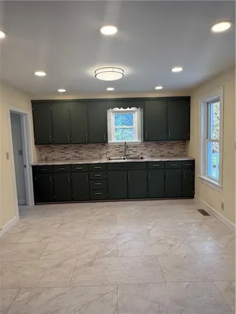 a large bathroom with a large tub and sink
