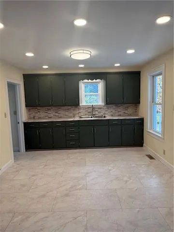 a large bathroom with a large tub and sink