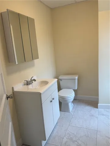 a bathroom with a sink a toilet and mirror
