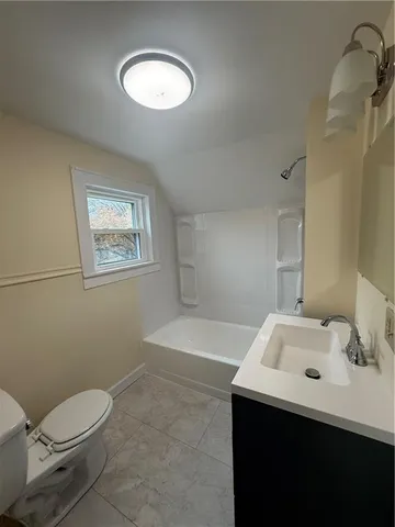 a bathroom with a sink toilet and a mirror