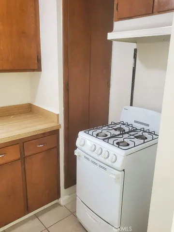 a stove top oven sitting inside of a kitchen