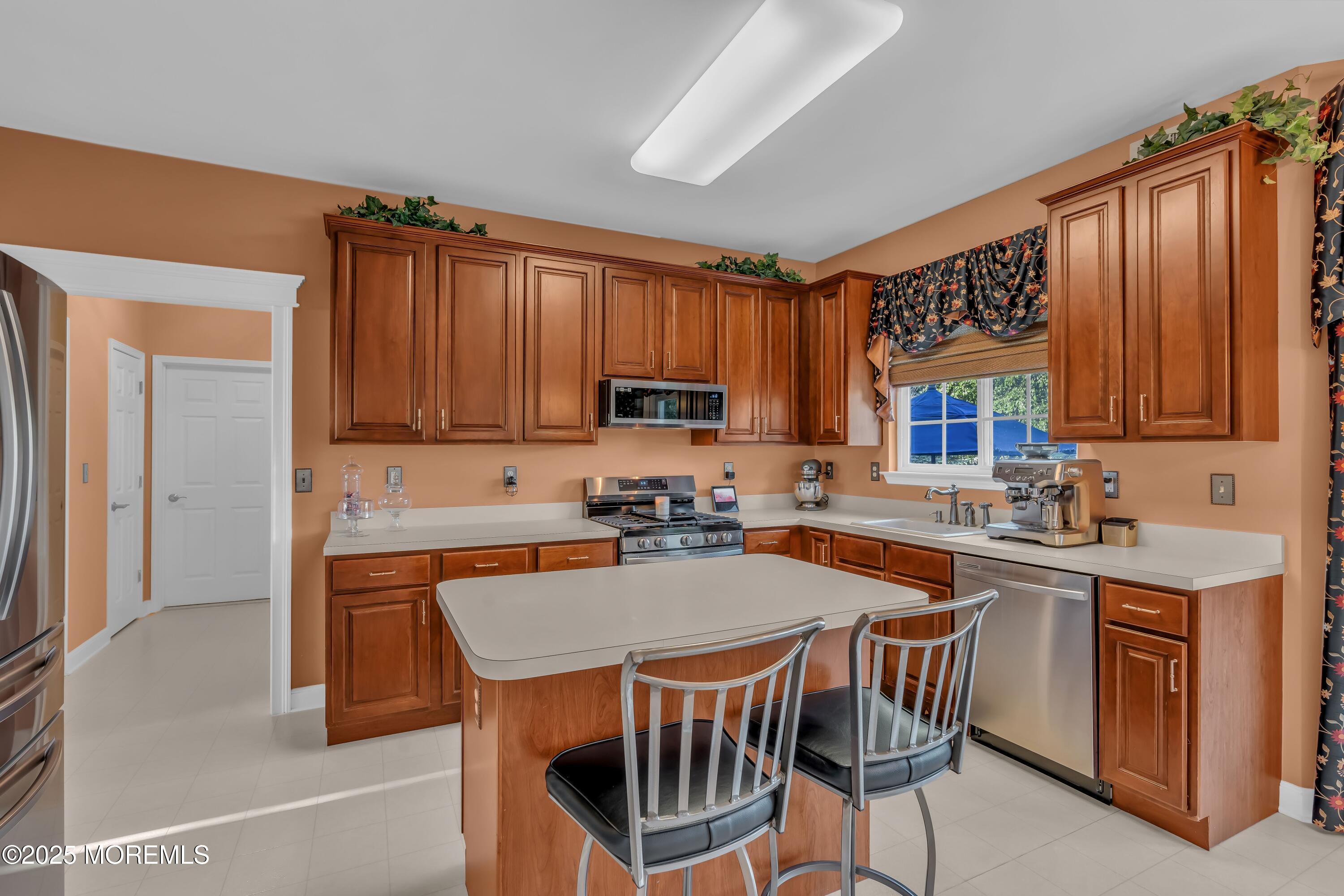 67 Picadilly Drive Jackson, NJ 08527 - Photo 17 of 49 a kitchen with a sink a stove cabinets and a window