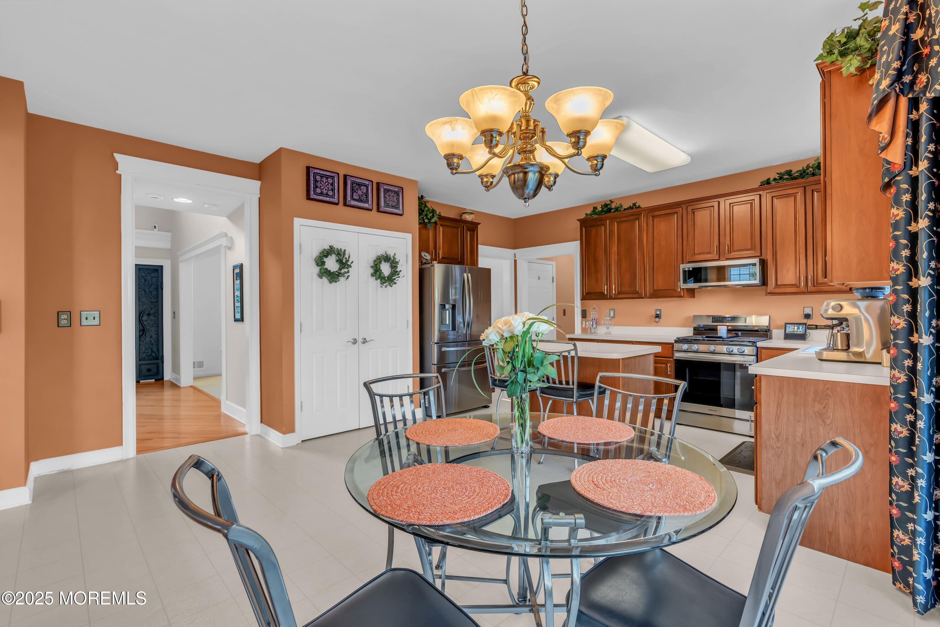 67 Picadilly Drive Jackson, NJ 08527 - Photo 19 of 49 a view of a dining room with furniture a chandelier and wooden floor