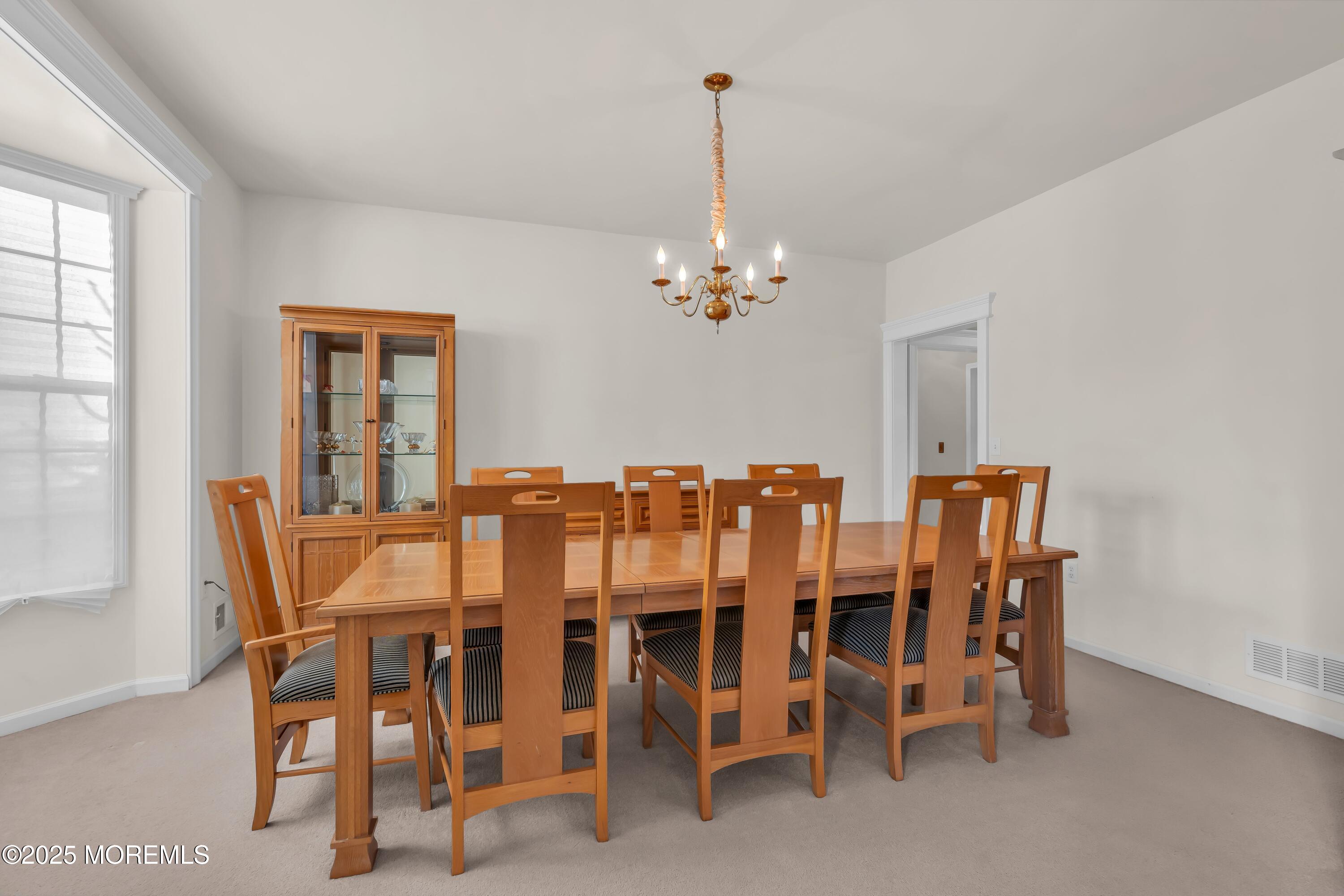 67 Picadilly Drive Jackson, NJ 08527 - Photo 10 of 49 a dining room with furniture a chandelier and window