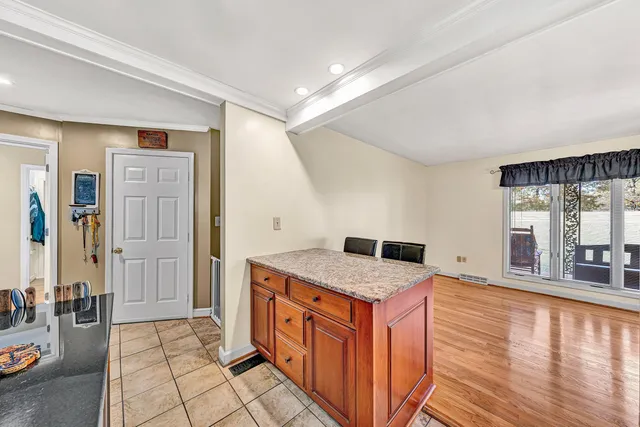 a kitchen with kitchen island a counter top space appliances and cabinets