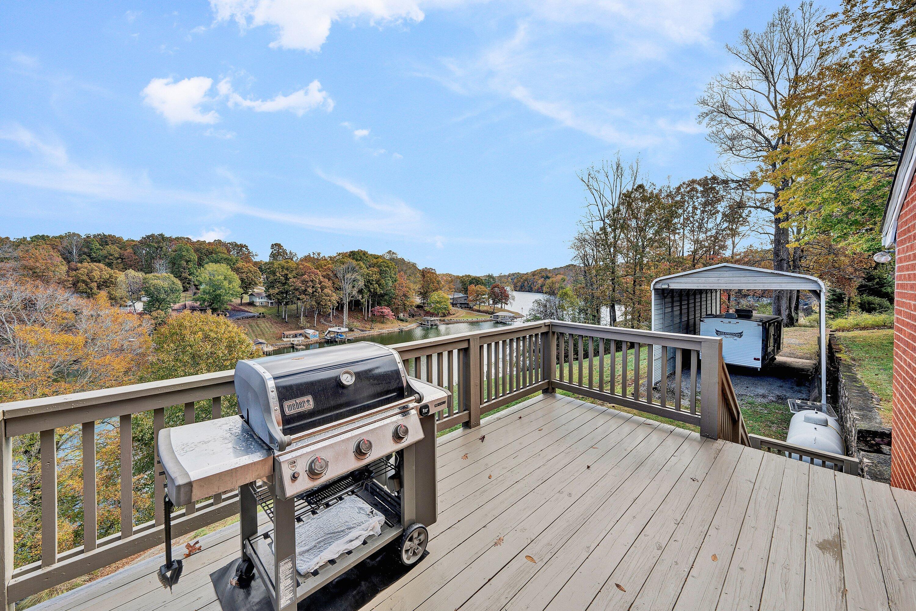 2228 Thomason Lane Goodview, VA 24095 - Photo 26 of 70 a view of a roof deck with table and chairs with wooden floor and fence