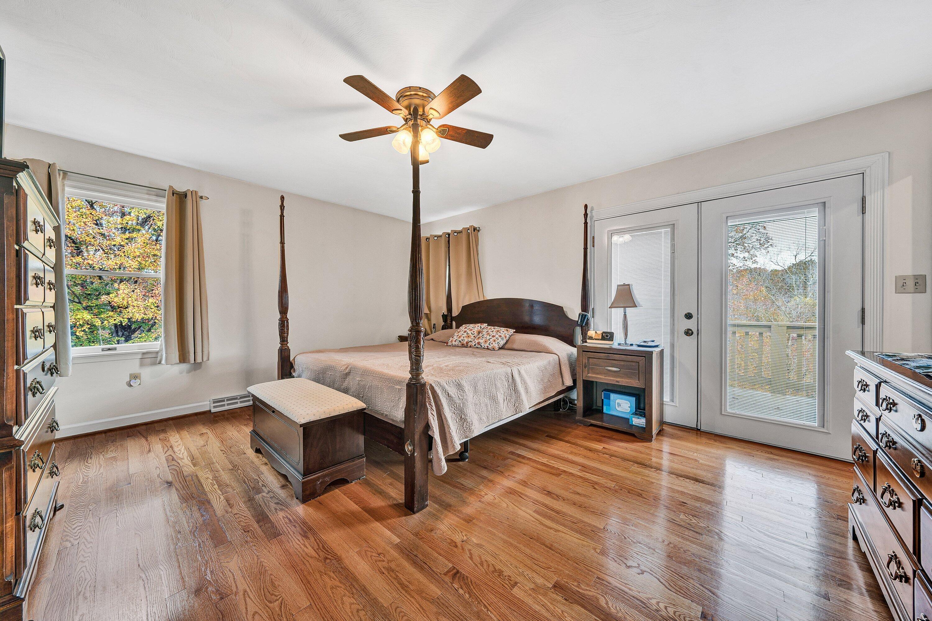 2228 Thomason Lane Goodview, VA 24095 - Photo 30 of 70 a bedroom with a bed and a chandelier