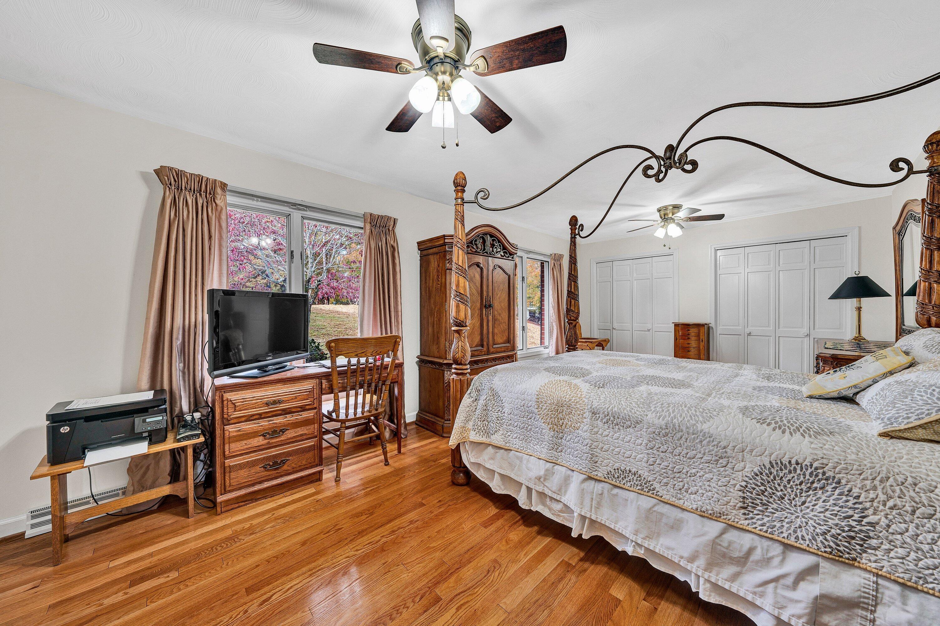2228 Thomason Lane Goodview, VA 24095 - Photo 33 of 70 a spacious bedroom with a bed and a flat screen tv