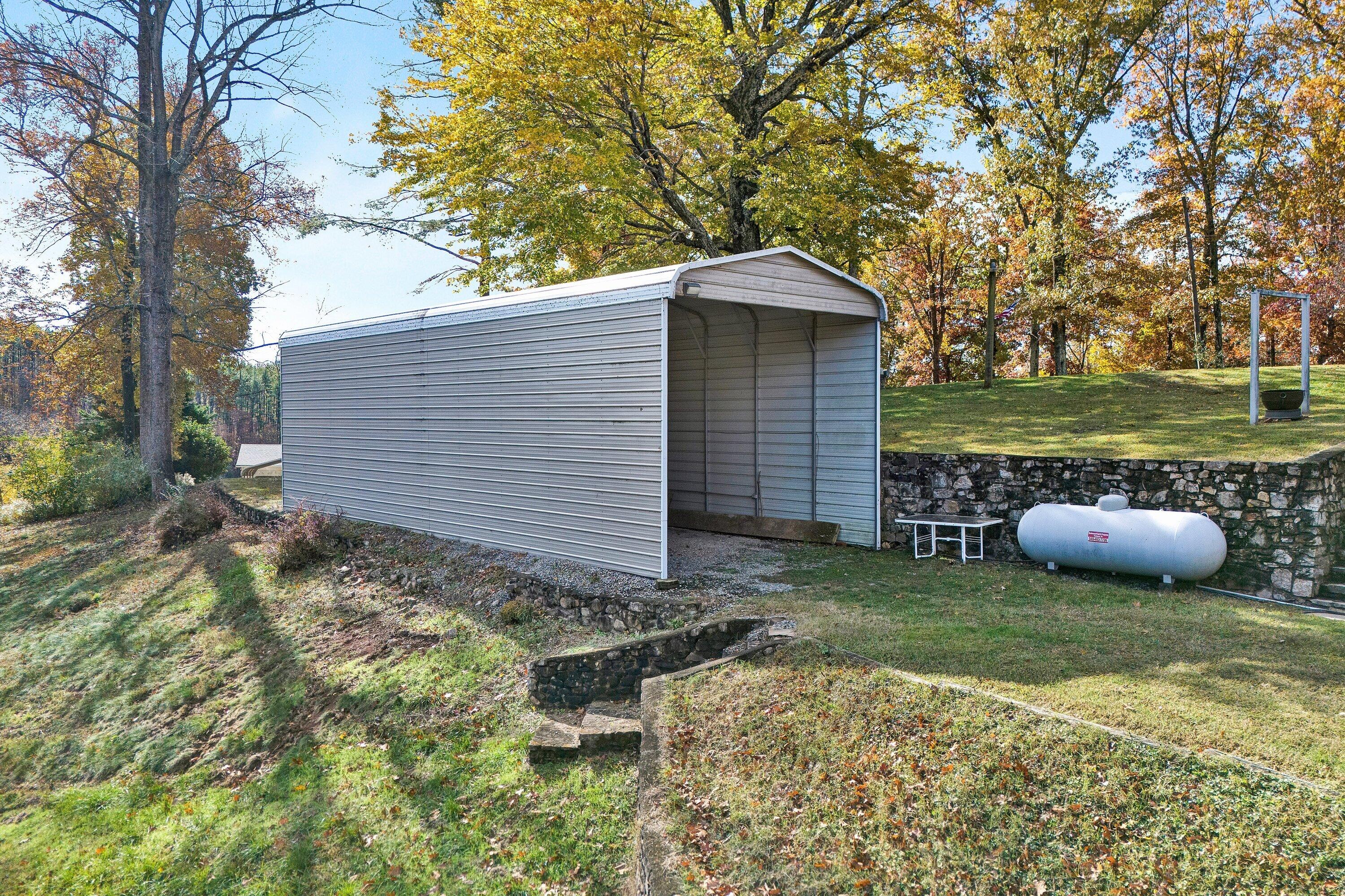 2228 Thomason Lane Goodview, VA 24095 - Photo 43 of 70 a backyard of a house with table and chairs