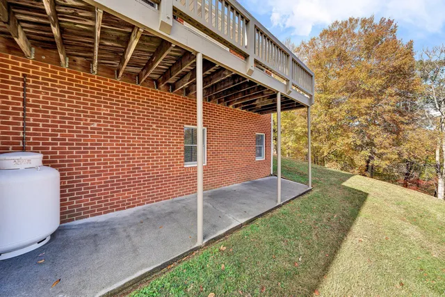 a view of a balcony with wooden floor and fence