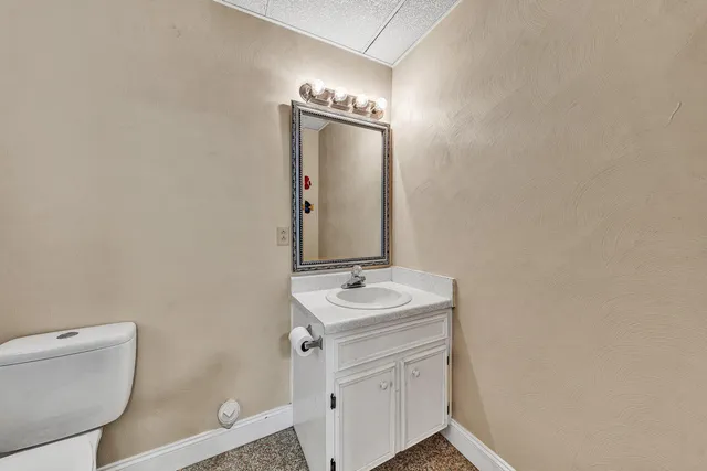 a balcony with wooden floor table and chairs