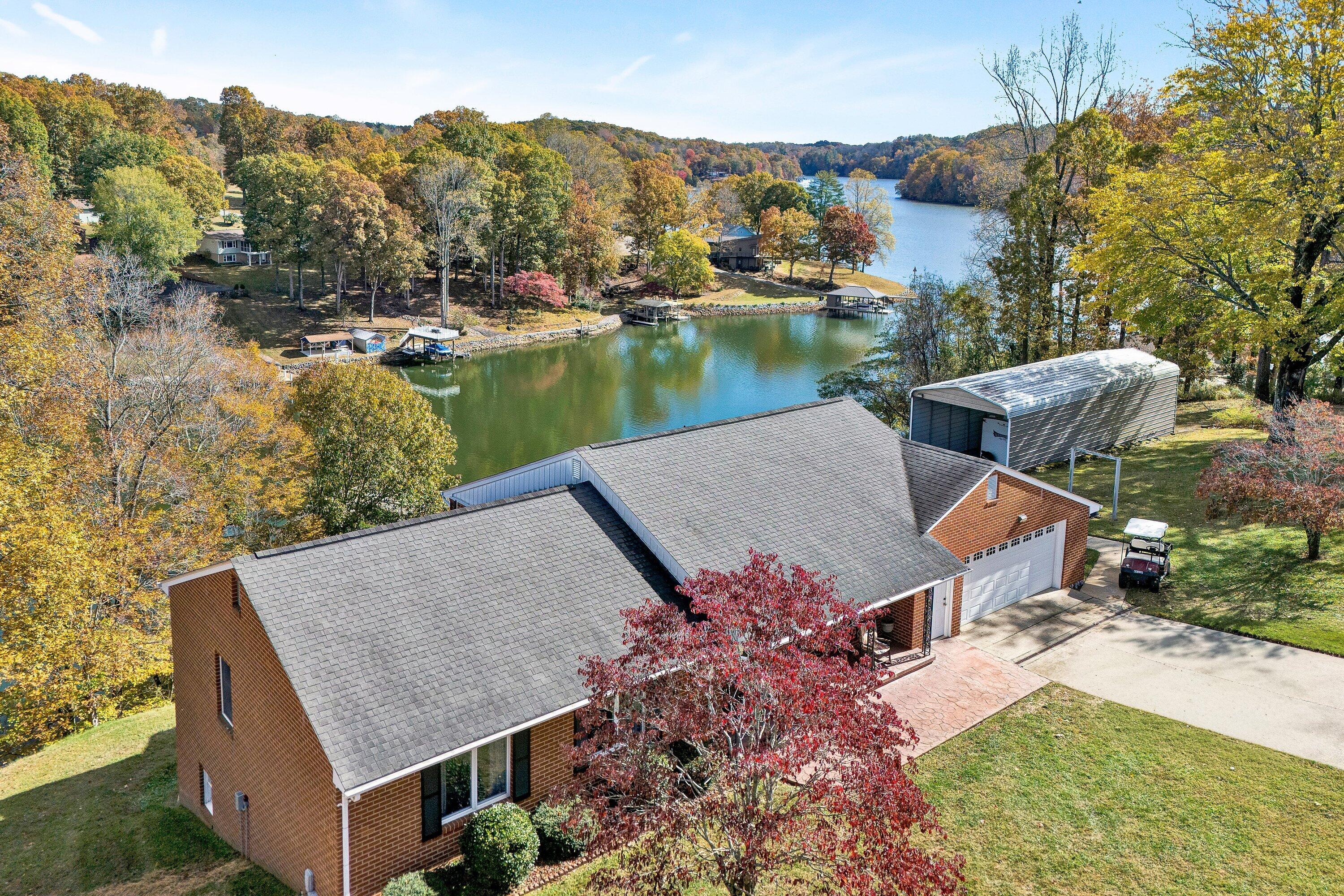 2228 Thomason Lane Goodview, VA 24095 - Photo 8 of 70 an aerial view of a house with a garden and lake view