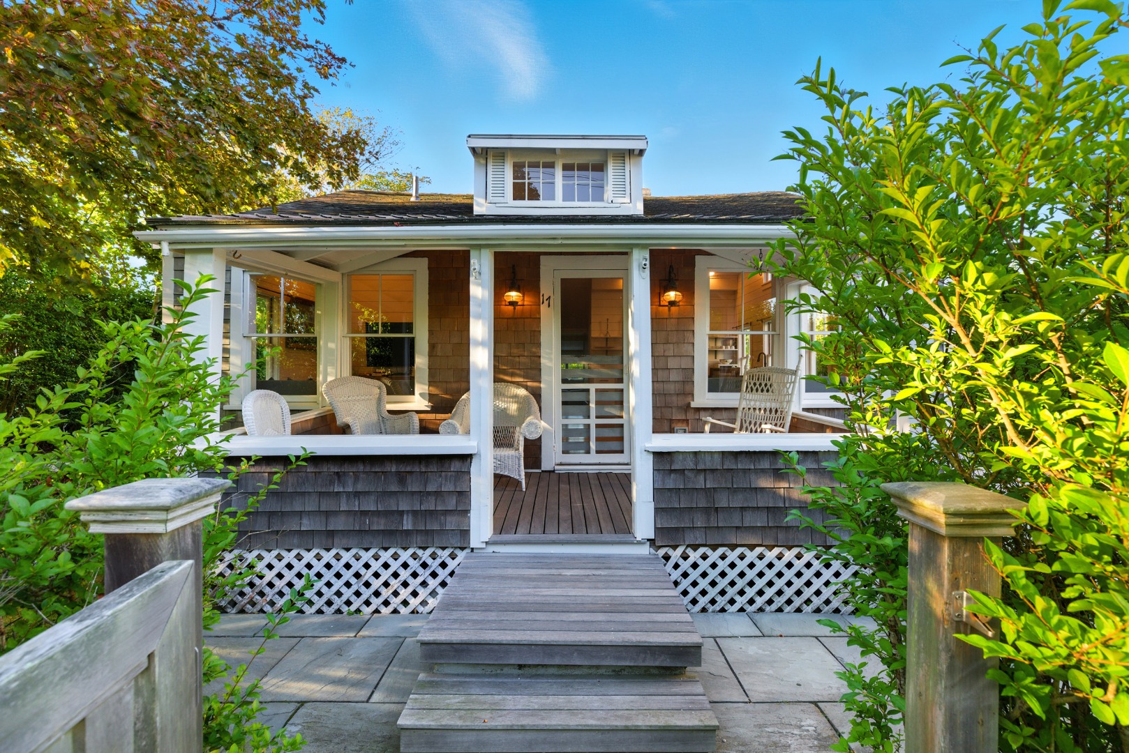 17 New Street Nantucket, MA 02554 - Photo 4 of 31 a view of a house with a bench in a garden