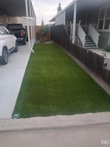 a view of a street with a car parked in the background